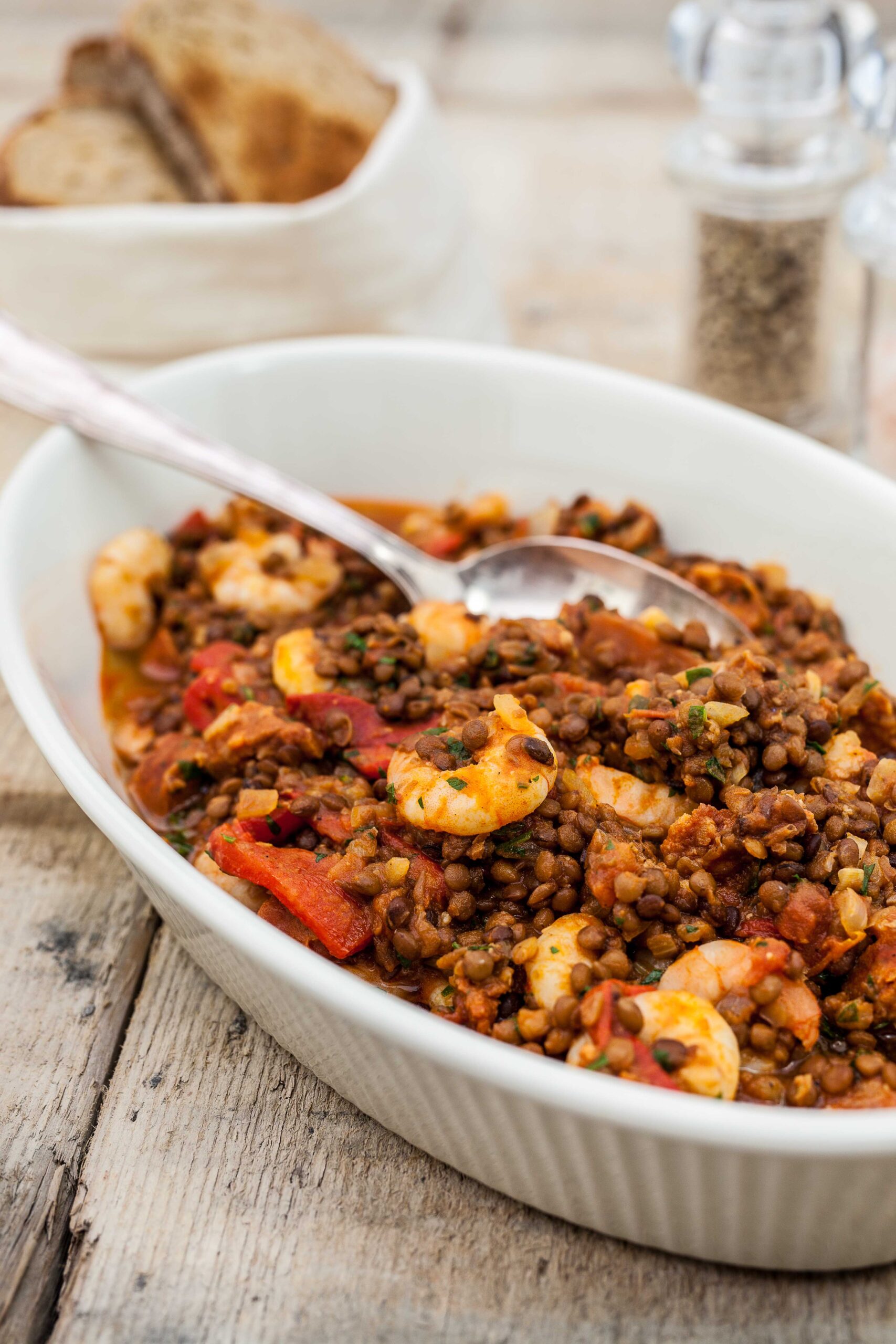 Gumbo made with mix, served with shrimp, sausage, okra, and steamed rice in a bowl.