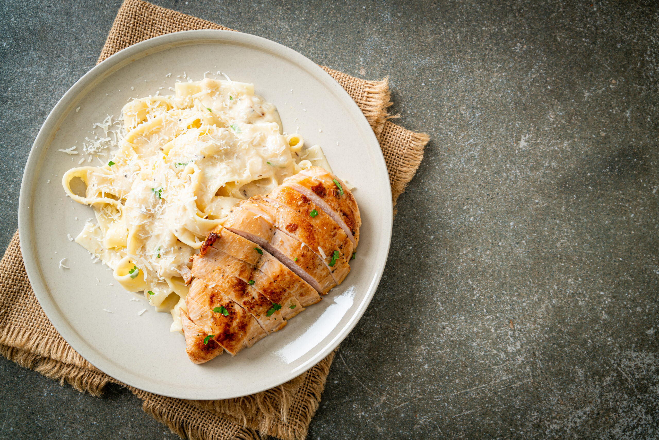 Garlic Parmesan Chicken Pasta with creamy sauce and fresh parsley garnish