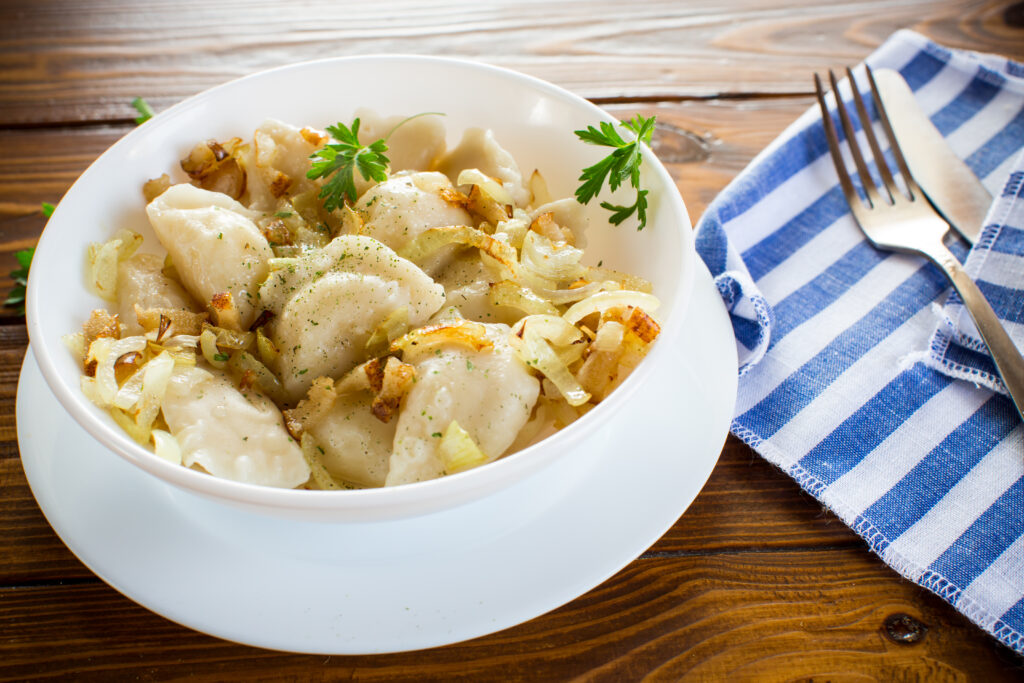 A hearty bowl of Bisquick chicken and dumplings with tender chicken, fluffy dumplings, and colorful vegetables like carrots and celery in a creamy broth.